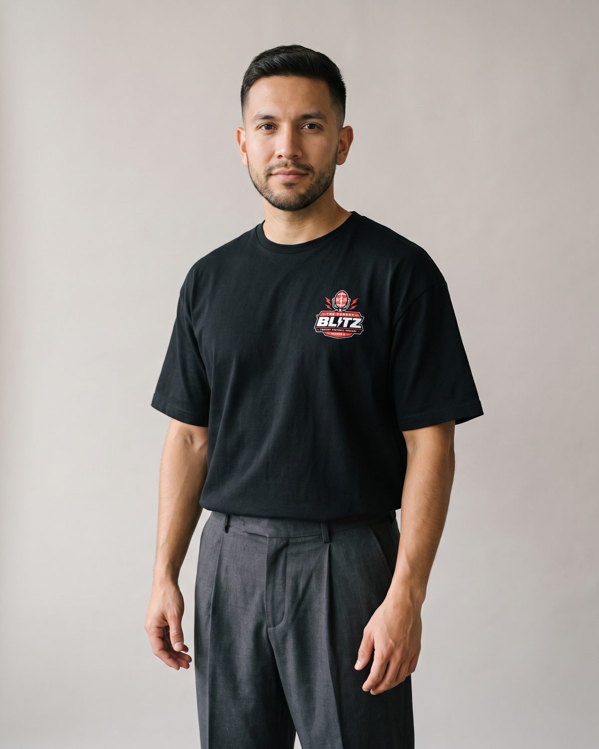 Man wearing the black Crest Heavyweight Tee with the Season 2 crest on the chest