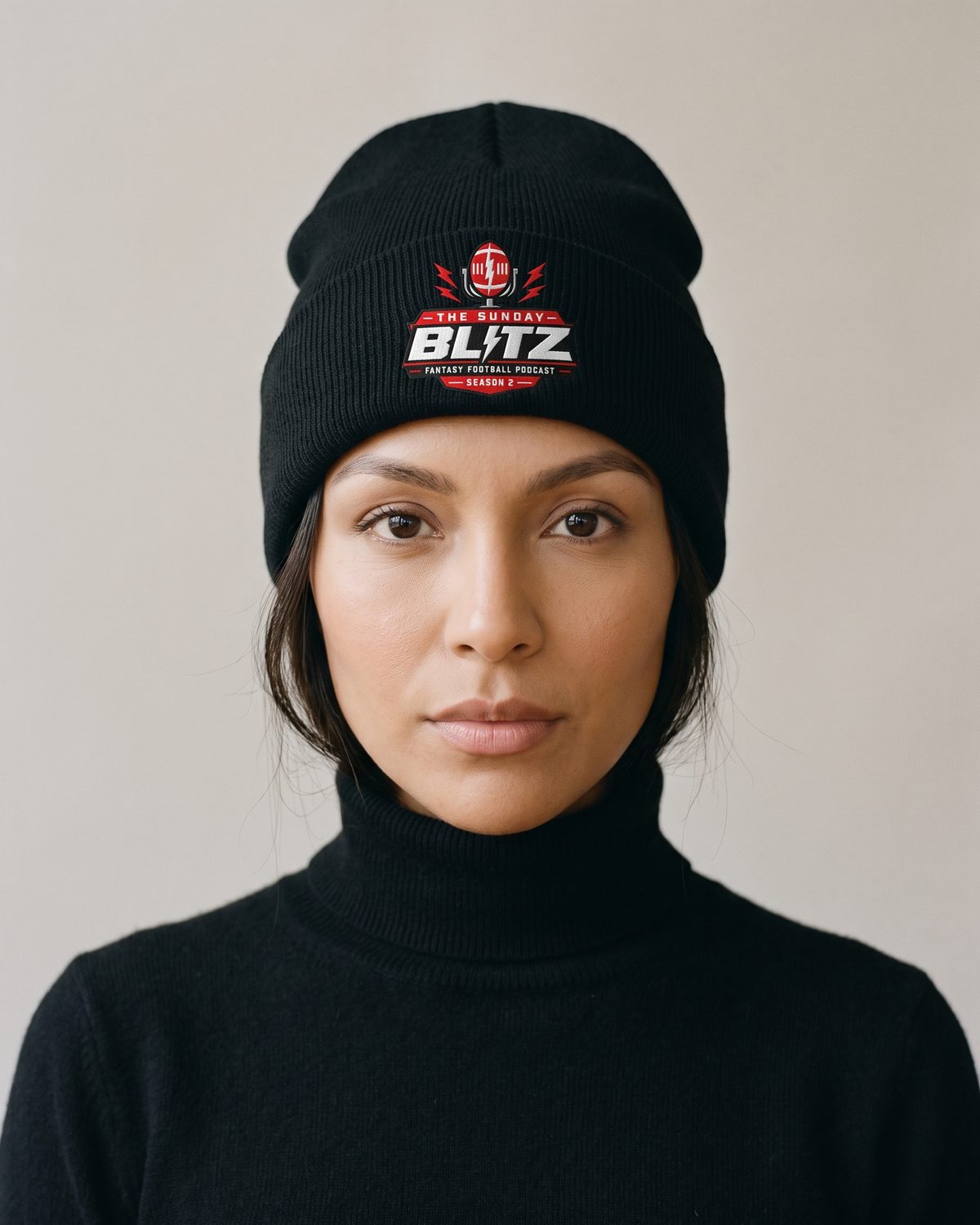 Woman in the black Crest Rib Beanie and a black rollneck